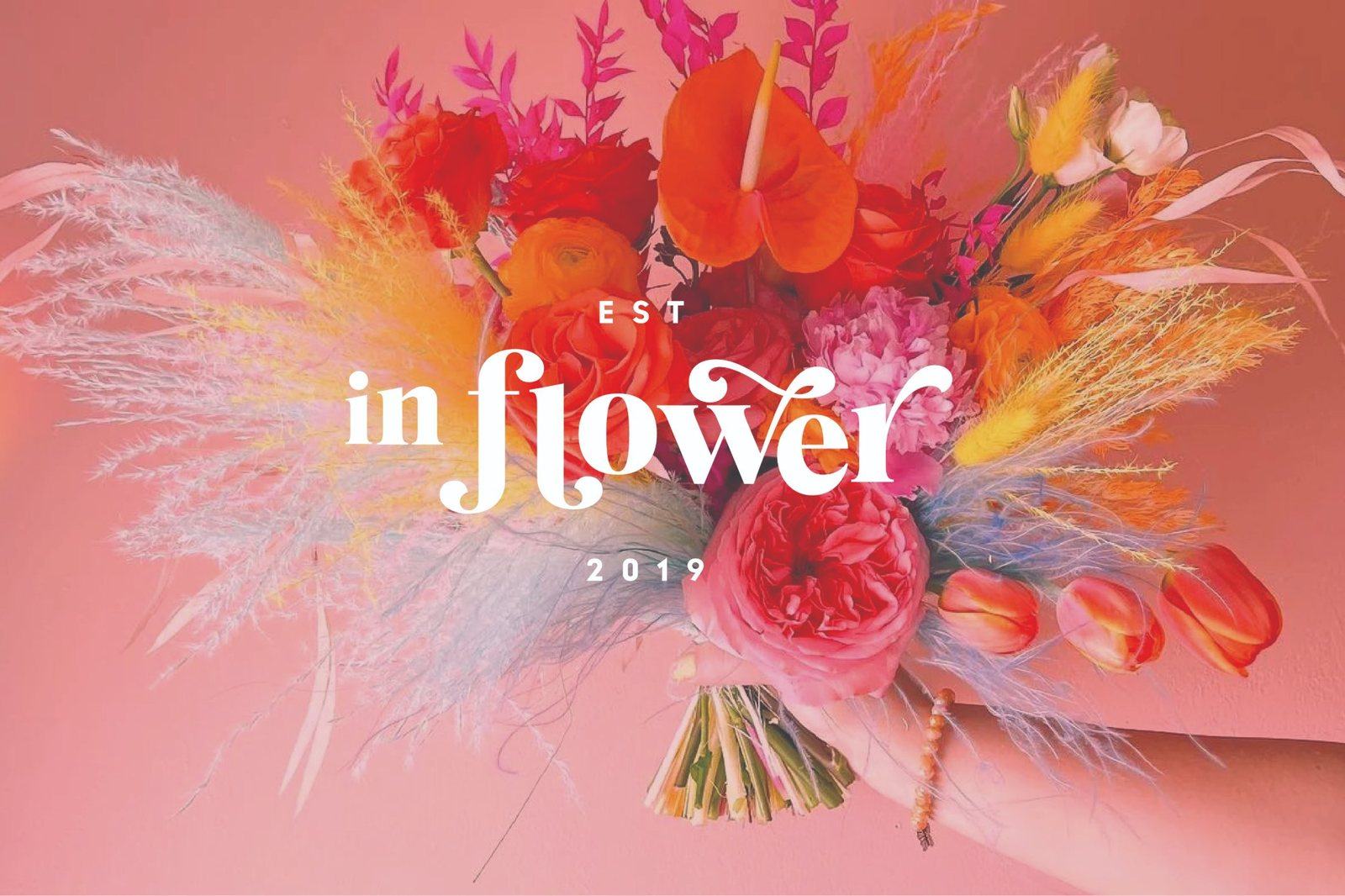 In Flower wordmark over a bright bouquet